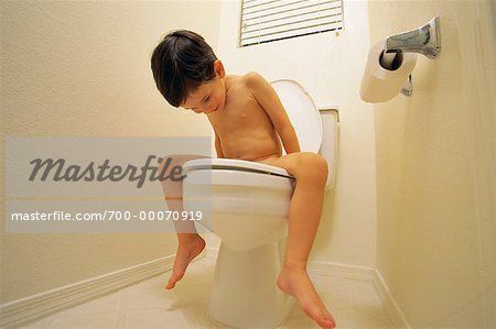 Boy nude in a toilet